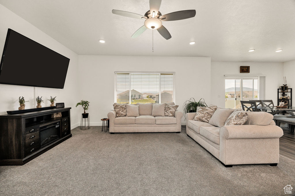 Living room with ceiling fan, recessed lighting, carpet floors, and baseboards