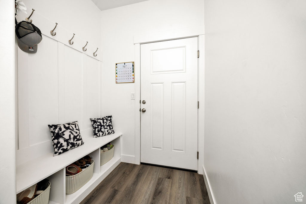 Mudroom with dark wood-style floors and baseboards