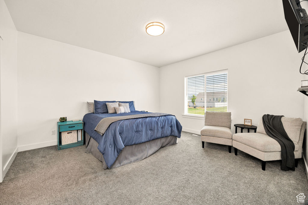 Carpeted bedroom featuring baseboards