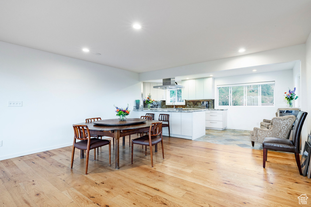 Dining area featuring recessed lighting and light wood-style flooring