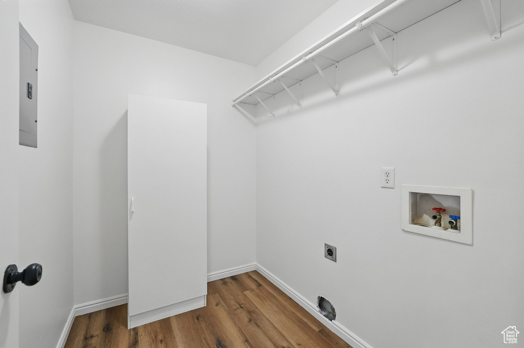 Washroom featuring washer hookup, hookup for an electric dryer, wood finished floors, and baseboards
