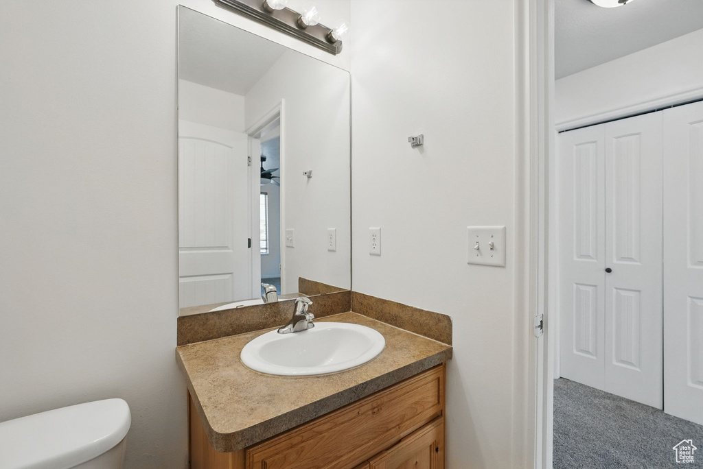 Half bath featuring vanity and toilet