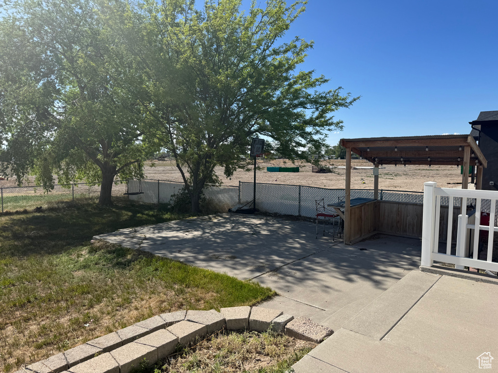 Fenced backyard featuring a patio