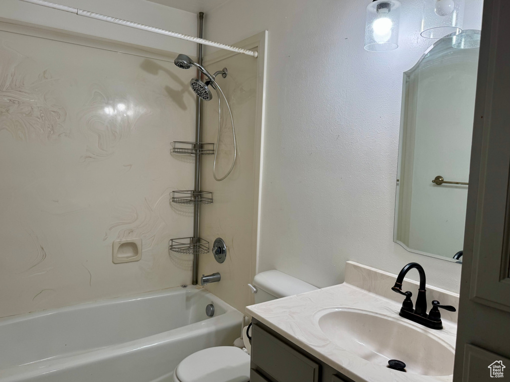 Full bath featuring toilet, vanity, and bathing tub / shower combination