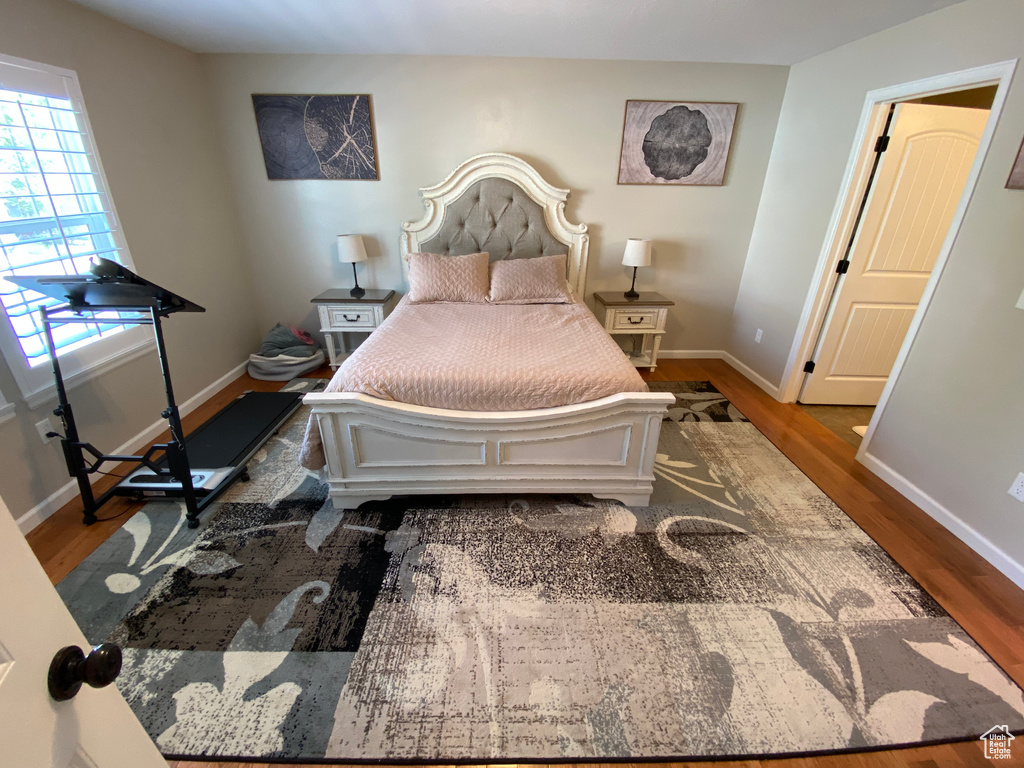 Bedroom featuring wood finished floors and baseboards