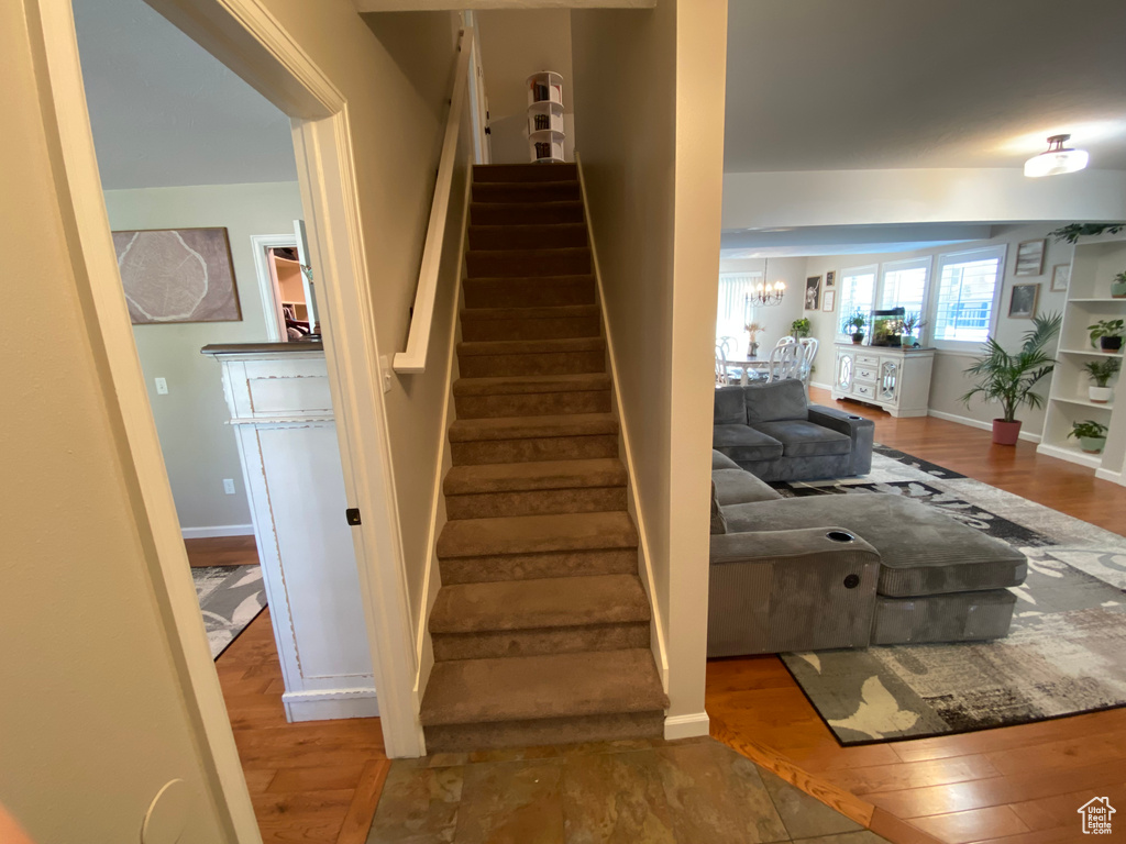 Staircase featuring hardwood / wood-style floors and baseboards