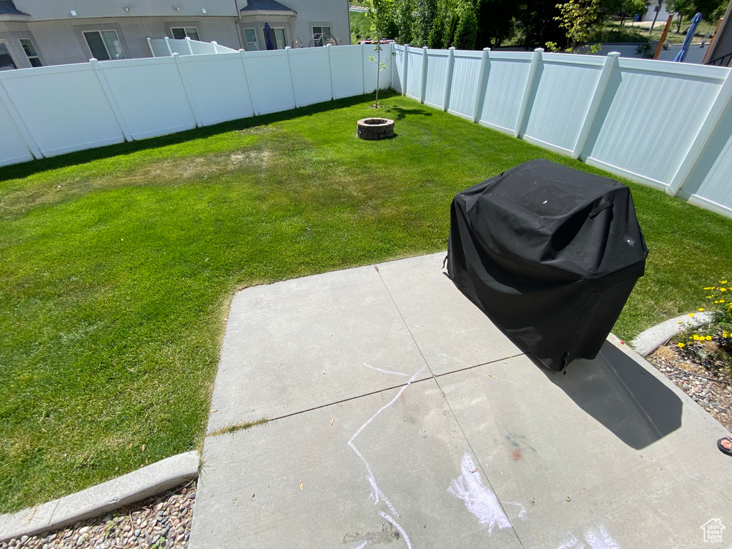 View of yard with a fire pit and a patio
