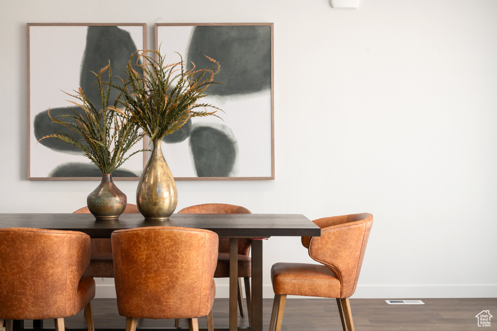 Dining space with baseboards and wood finished floors