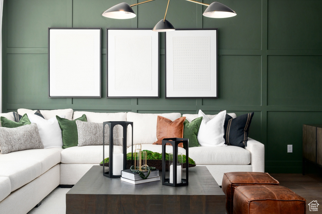 Living room featuring a decorative wall and wood finished floors