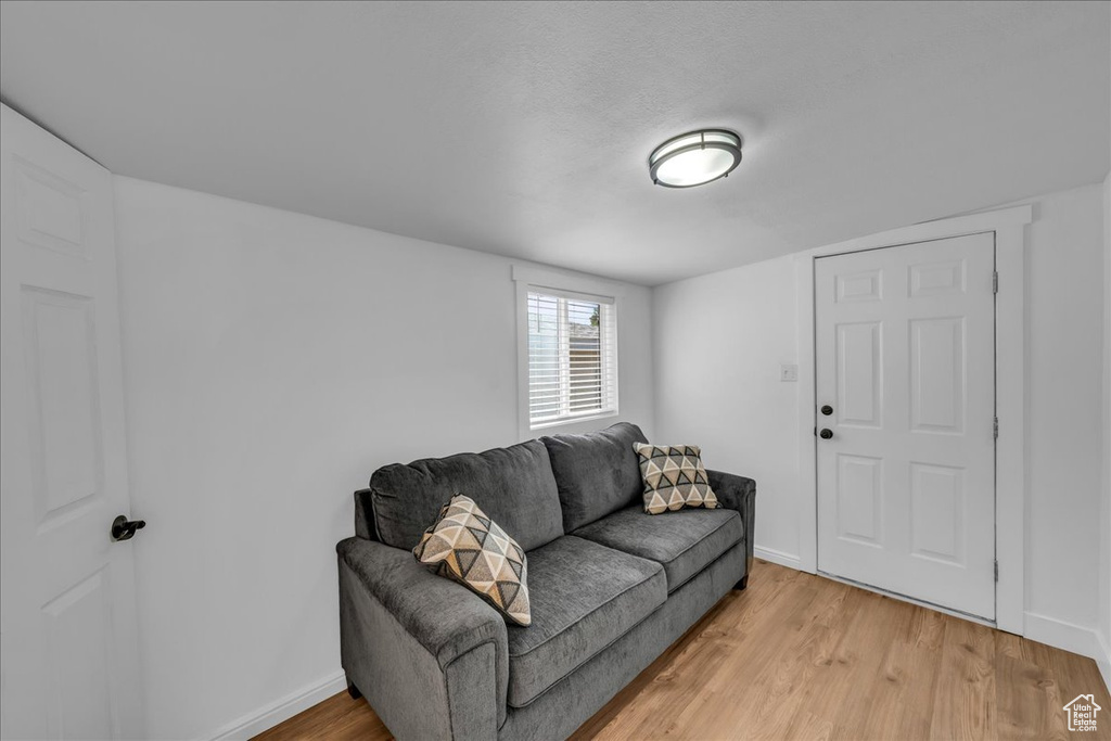 Living area featuring light wood-style flooring and baseboards