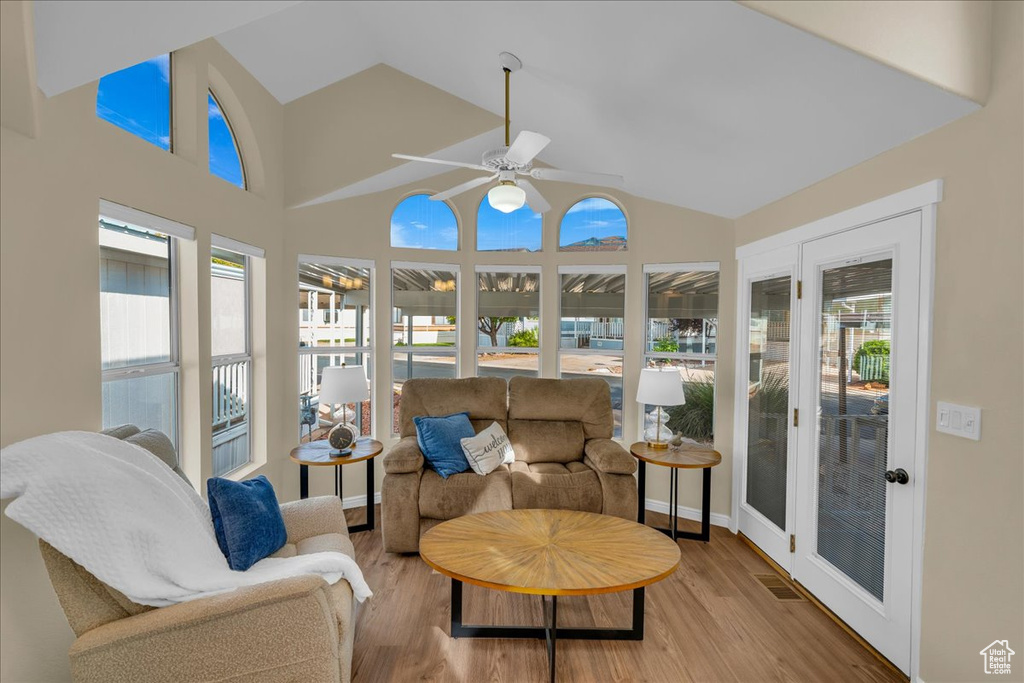 Sunroom / solarium with wood finished floors and high vaulted ceiling