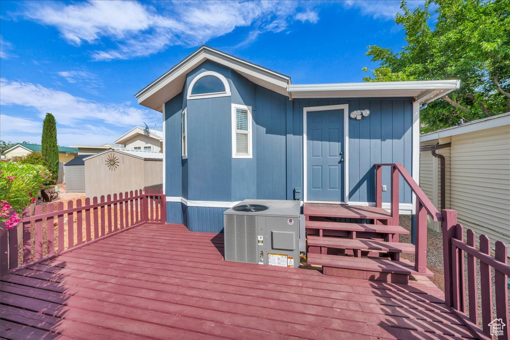 Wooden deck featuring central AC unit