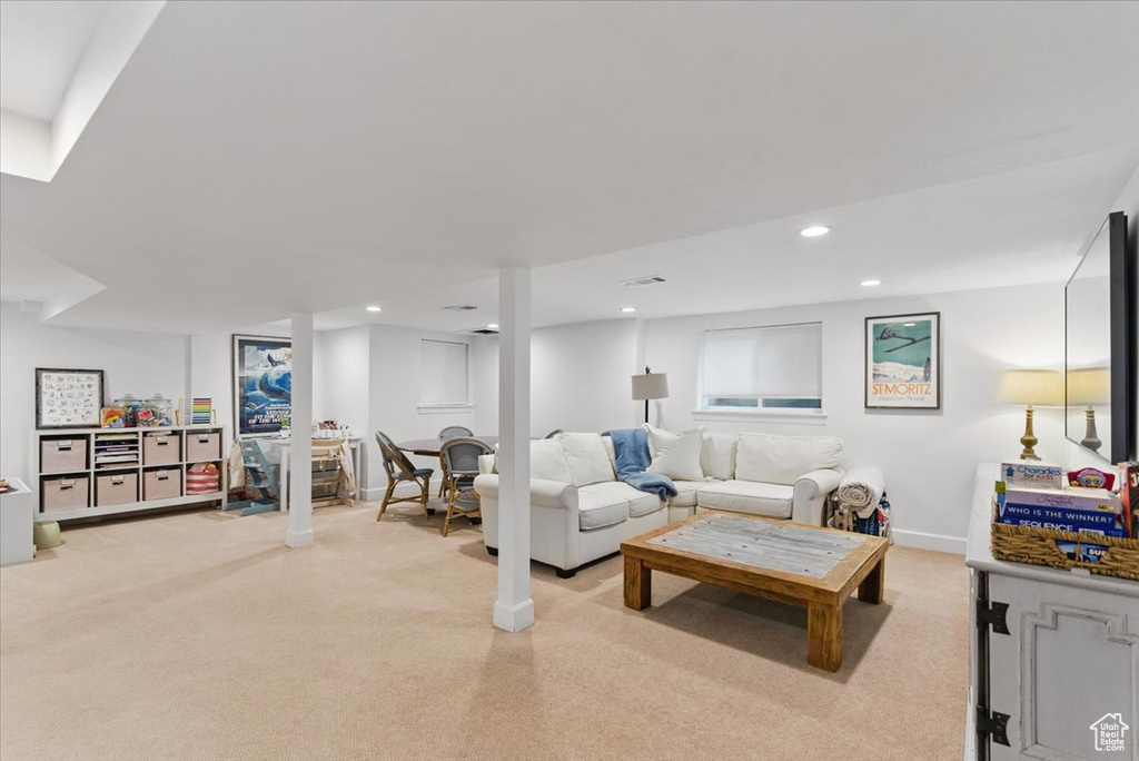 Living area featuring light carpet, recessed lighting, and baseboards