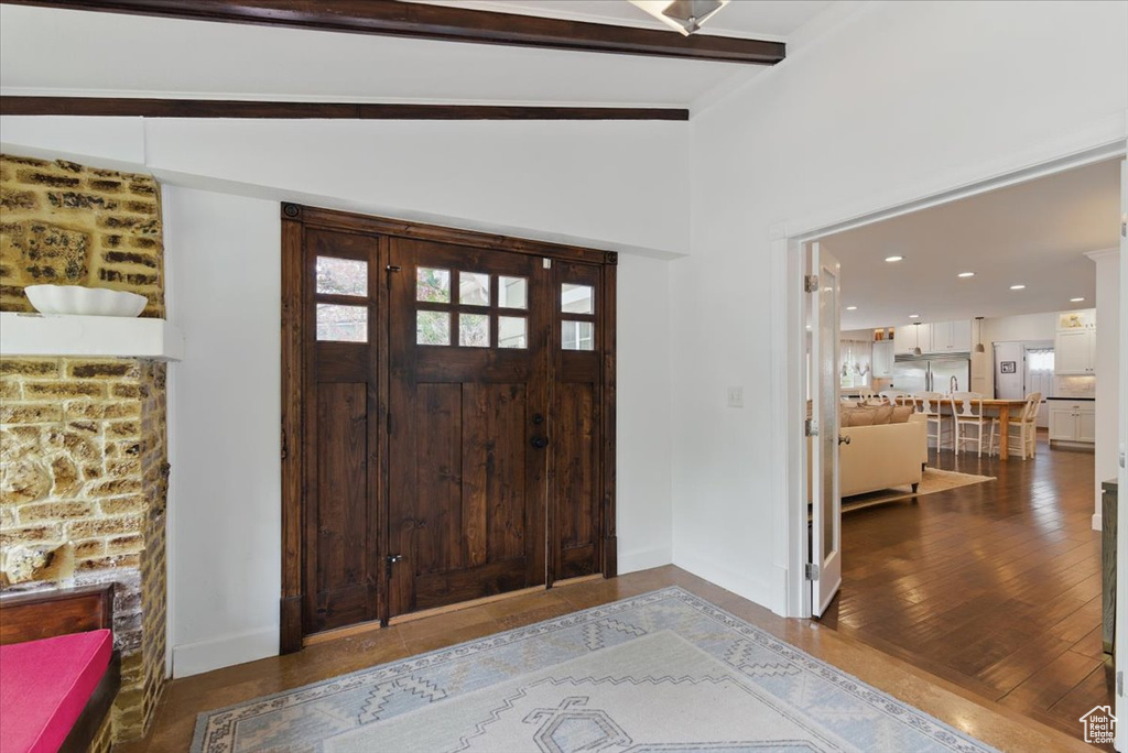 Foyer with baseboards, wood finished floors, and recessed lighting