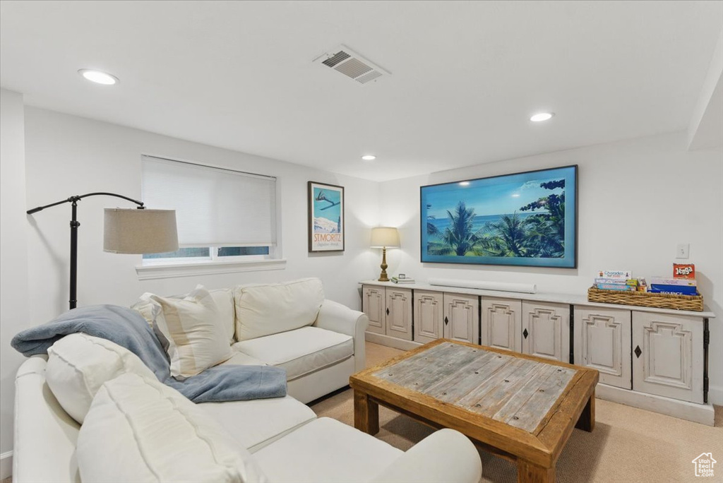 Living area featuring recessed lighting and light carpet