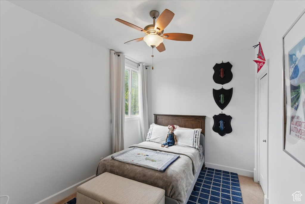 Bedroom featuring baseboards and ceiling fan