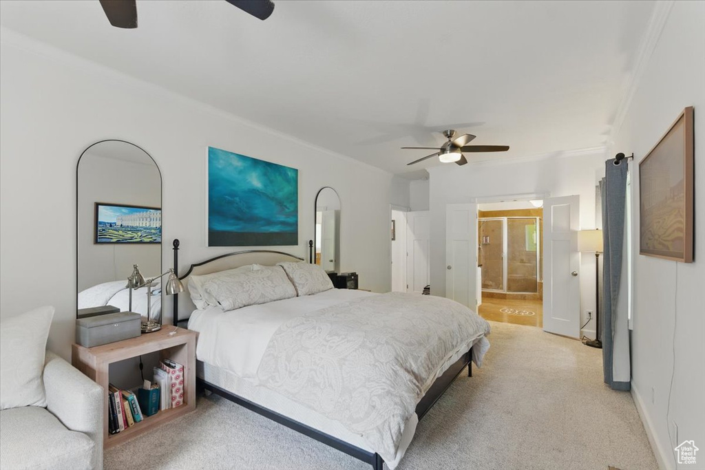 Bedroom featuring crown molding, light carpet, ceiling fan, and ensuite bath