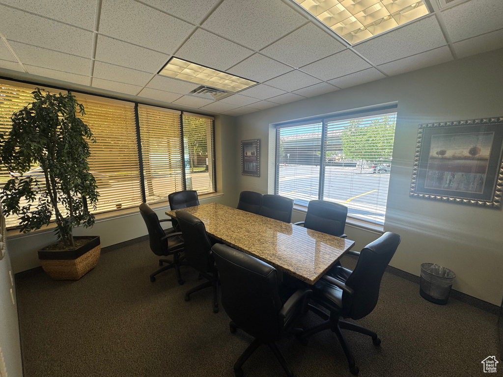 Office area featuring a paneled ceiling, carpet, and baseboards
