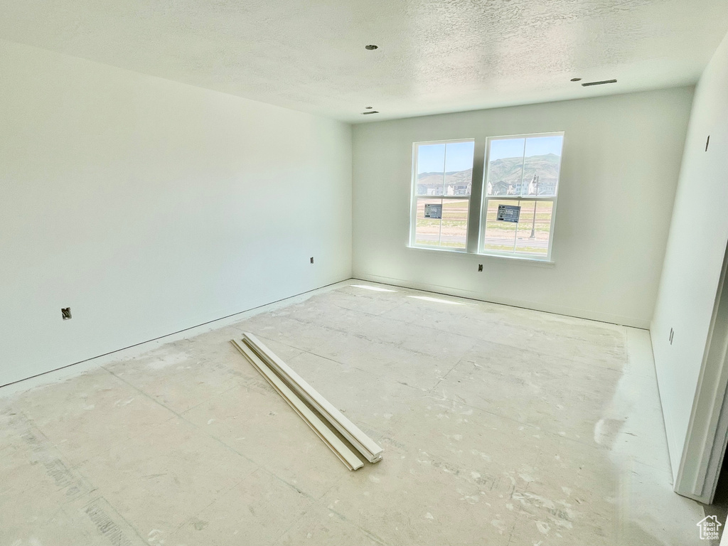 Spare room featuring a textured ceiling
