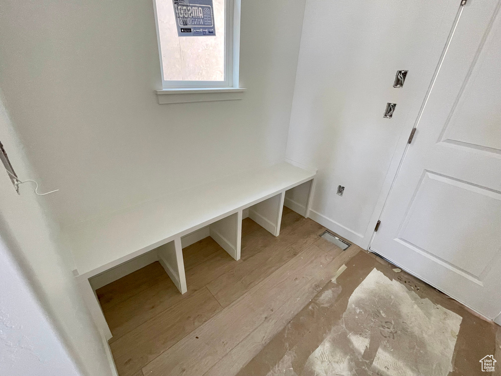 Mudroom featuring light wood-type flooring and baseboards