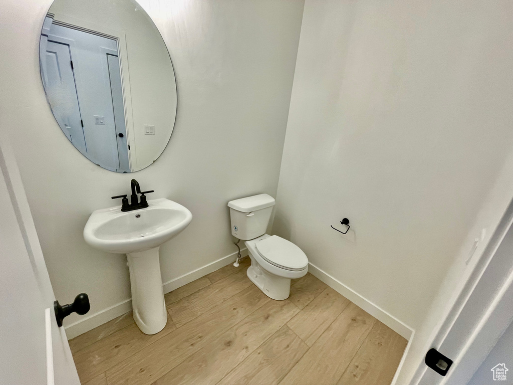 Bathroom with wood finished floors and toilet