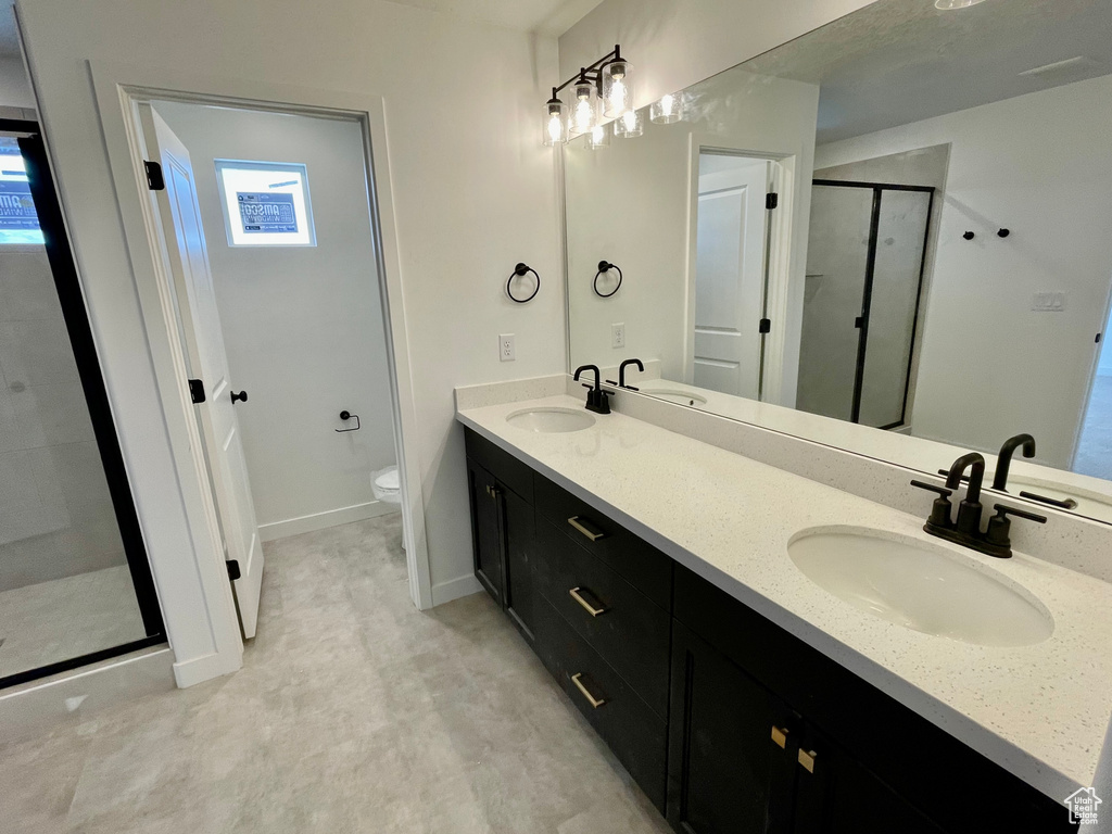 Bathroom with a shower stall and double vanity