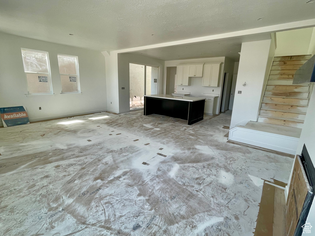 Unfurnished living room with stairway