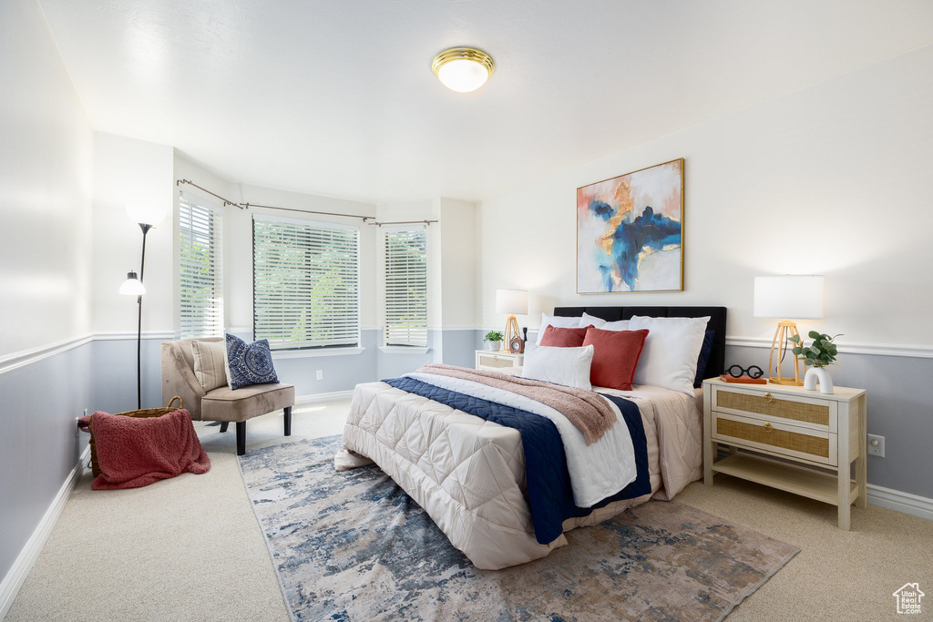Bedroom featuring carpet and baseboards