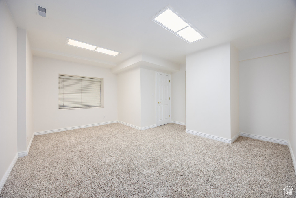 Empty room with carpet and baseboards