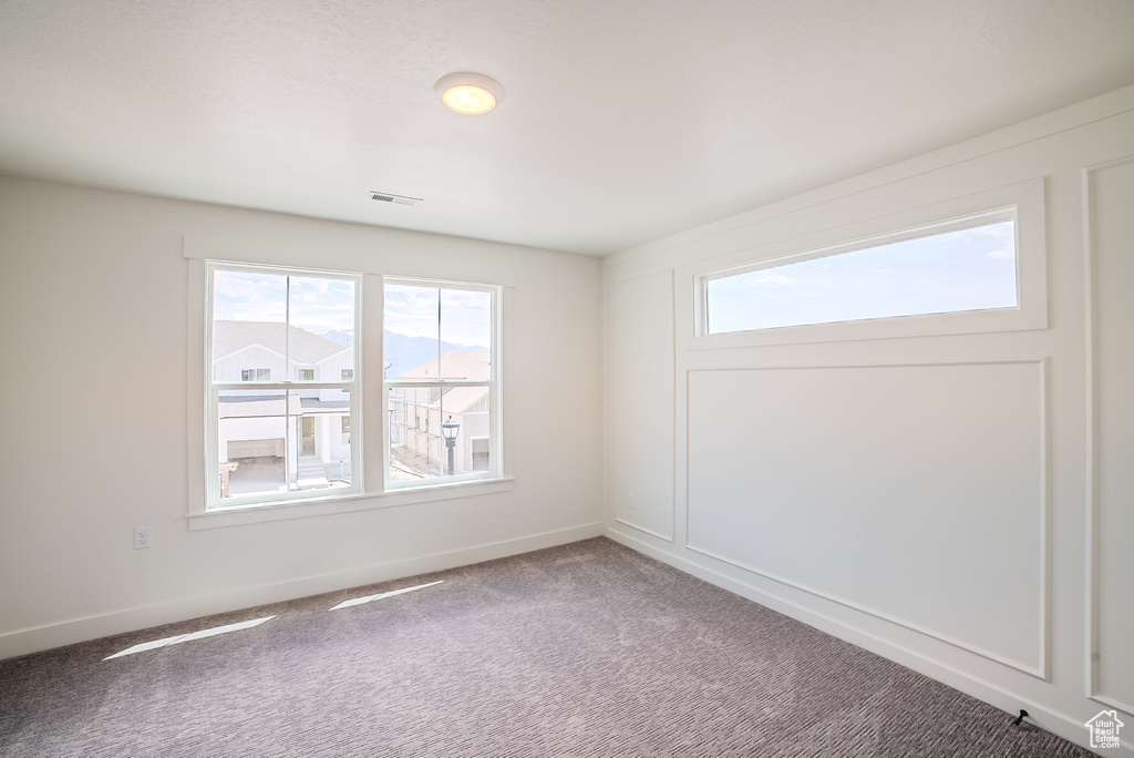 Spare room with carpet floors and baseboards
