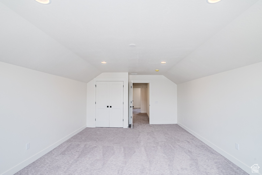 Additional living space with carpet, lofted ceiling, baseboards, and recessed lighting