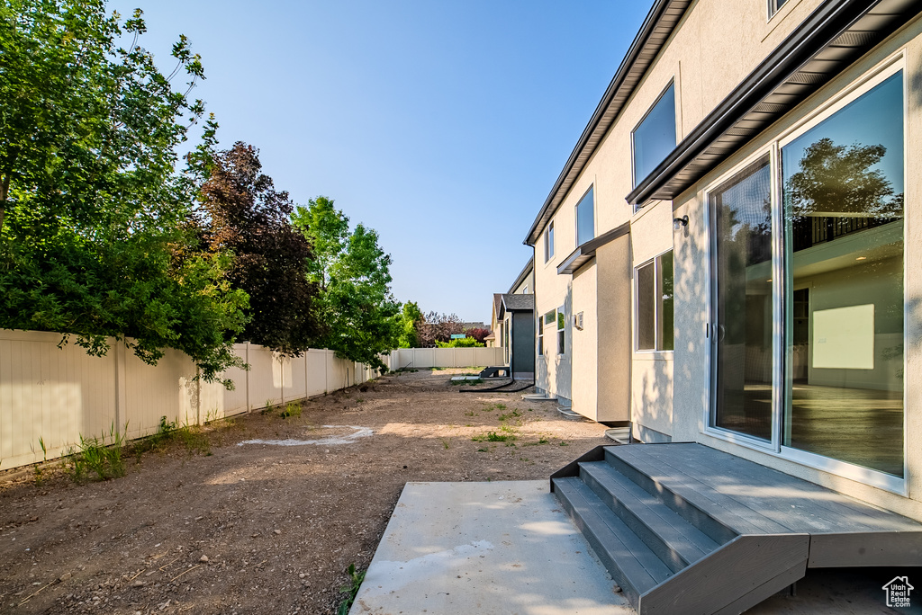 Fenced backyard featuring a patio
