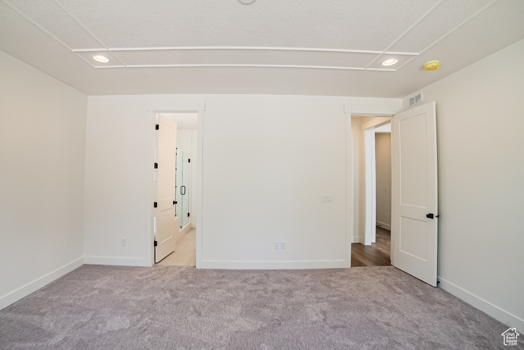 Unfurnished room featuring carpet floors, baseboards, and recessed lighting
