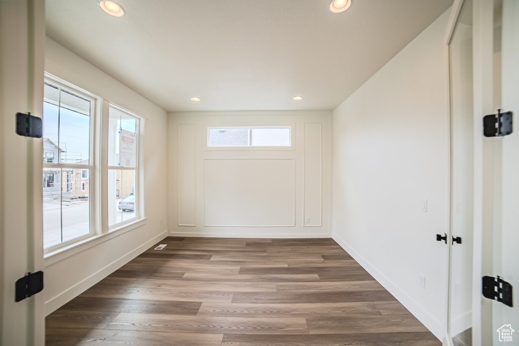 Empty room with recessed lighting, baseboards, and wood finished floors