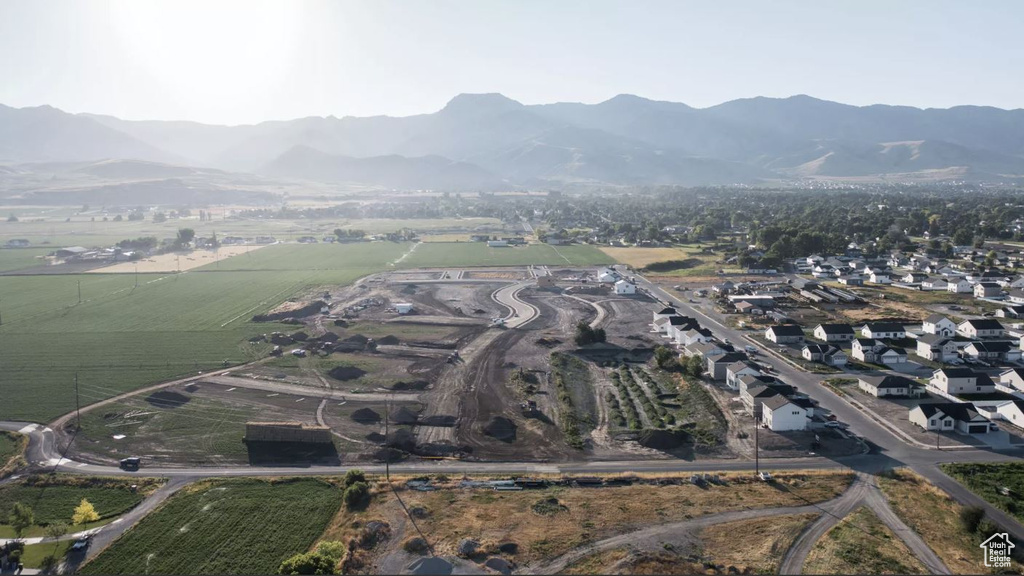Aerial view of property's location featuring a mountainous background and rural landscape