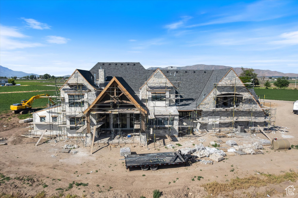 Back of property featuring a mountain view and stone siding