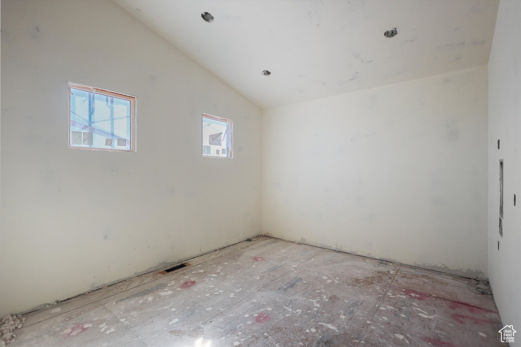 Spare room with vaulted ceiling