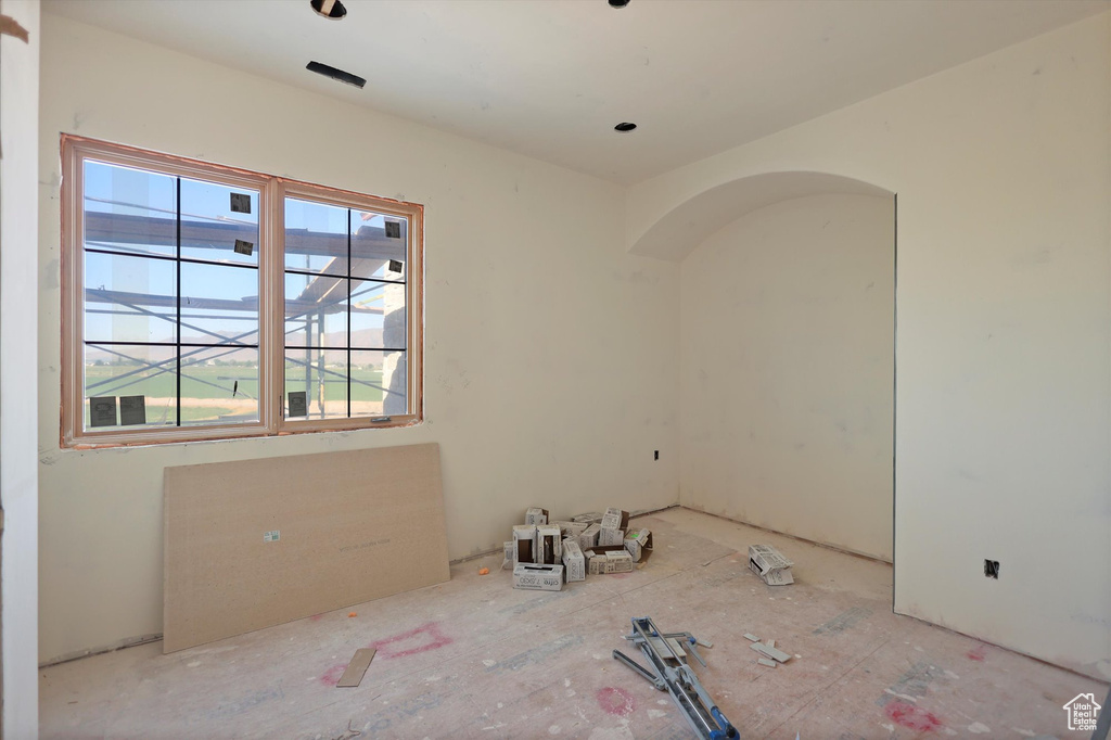 Spare room featuring arched walkways