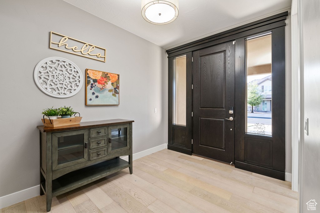 Entrance foyer featuring light wood-type flooring and baseboards