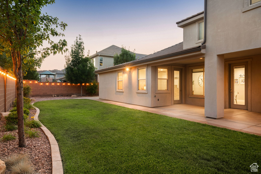 Yard at dusk with a patio area