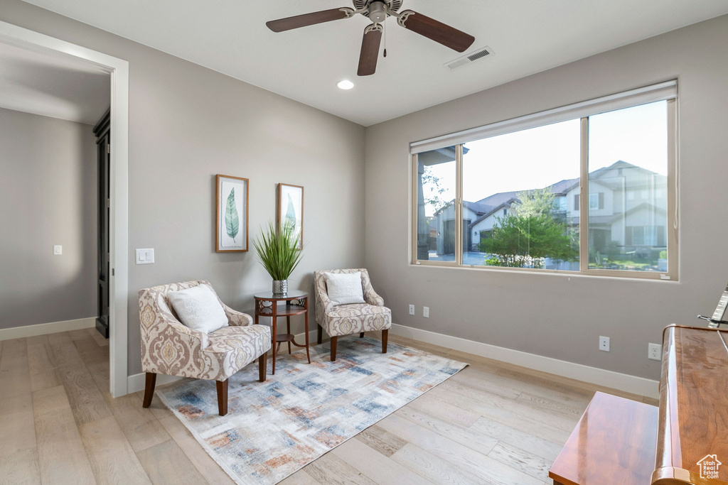 Living area with light wood finished floors, recessed lighting, a ceiling fan, and baseboards