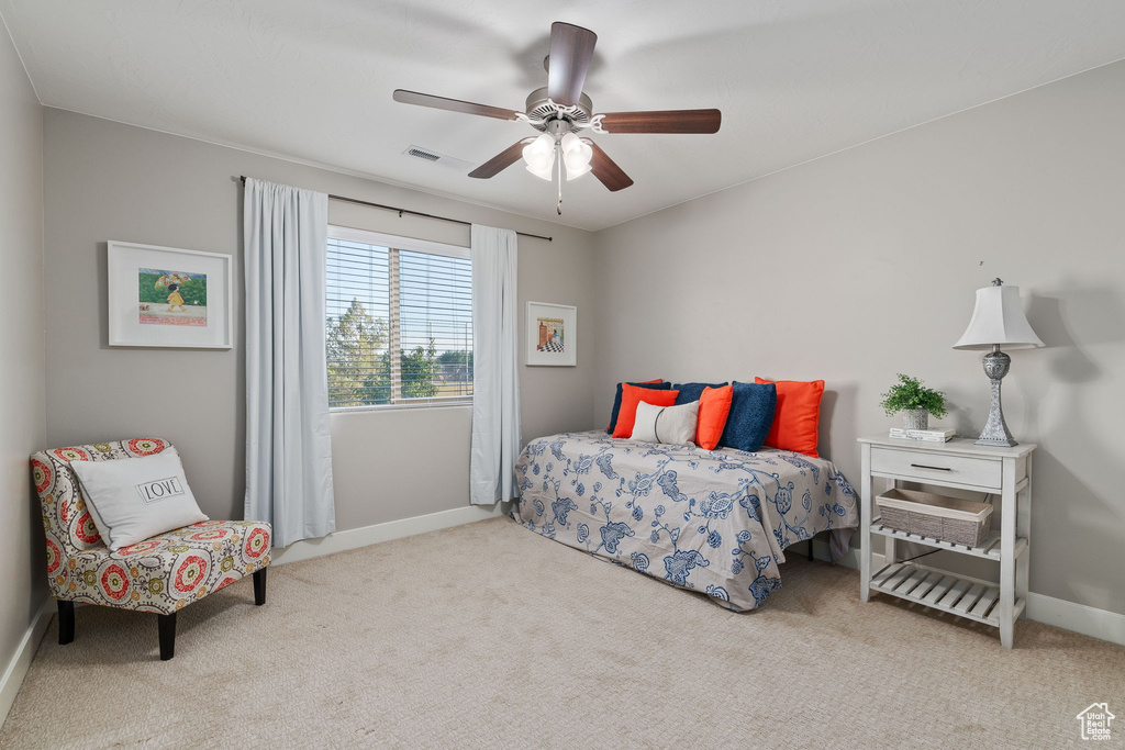 Carpeted bedroom featuring baseboards and a ceiling fan