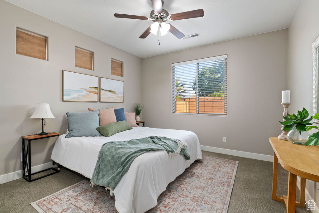 Bedroom with carpet flooring, baseboards, and a ceiling fan