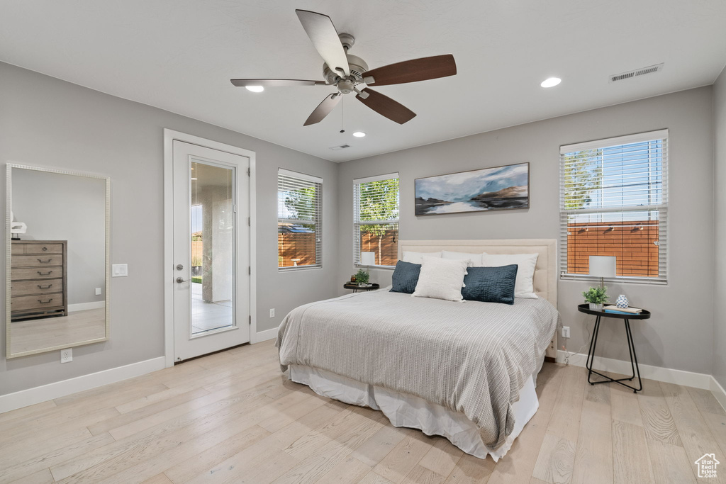 Bedroom with light wood-type flooring, baseboards, recessed lighting, ceiling fan, and access to exterior