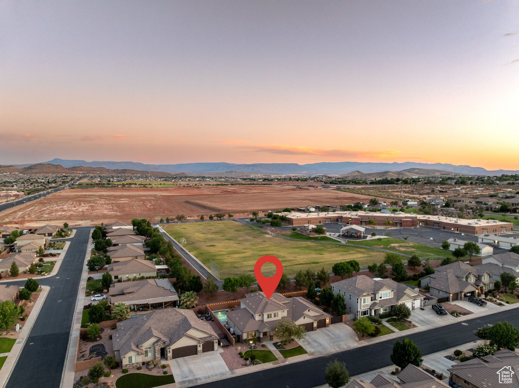 Aerial view of property's location featuring a mountain backdrop and nearby suburban area