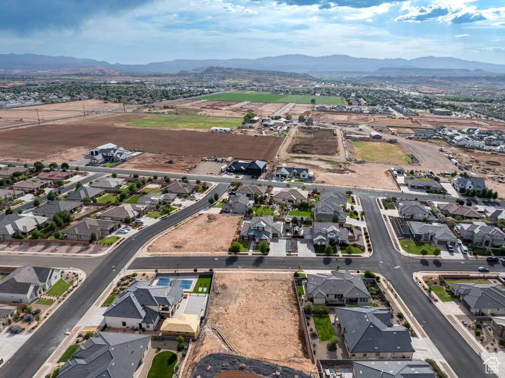 Aerial view of property's location with a mountainous background and nearby suburban area