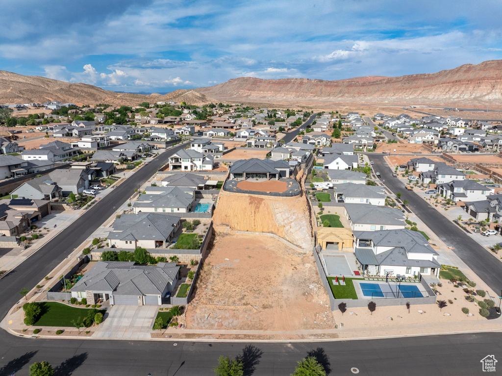 Aerial overview of property's location with nearby suburban area and mountains