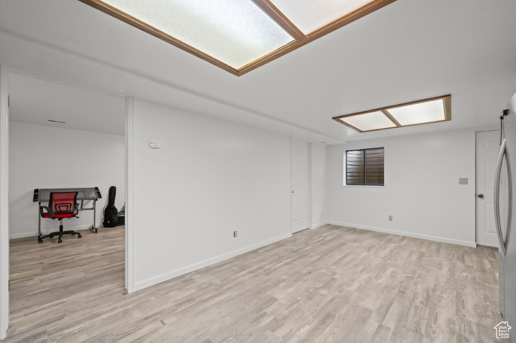 Empty room with light wood finished floors and baseboards
