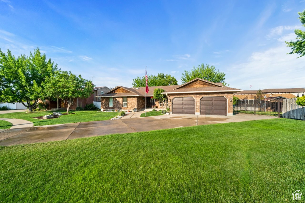 Single story home featuring a garage and concrete driveway
