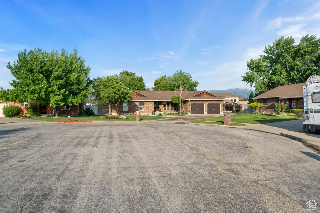 Ranch-style house featuring a garage and a residential view